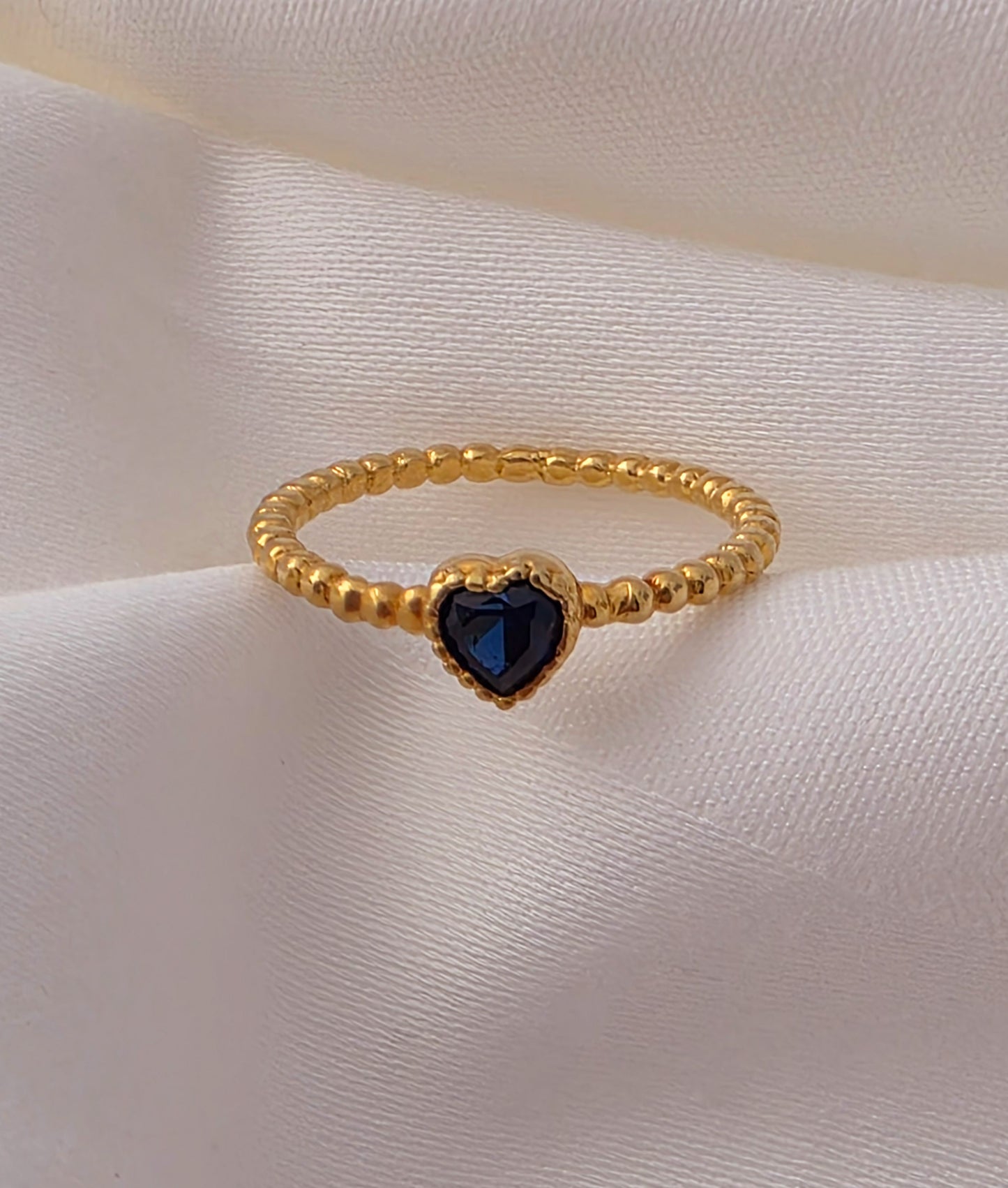 Twisted Gold Ring with Blue Stone.