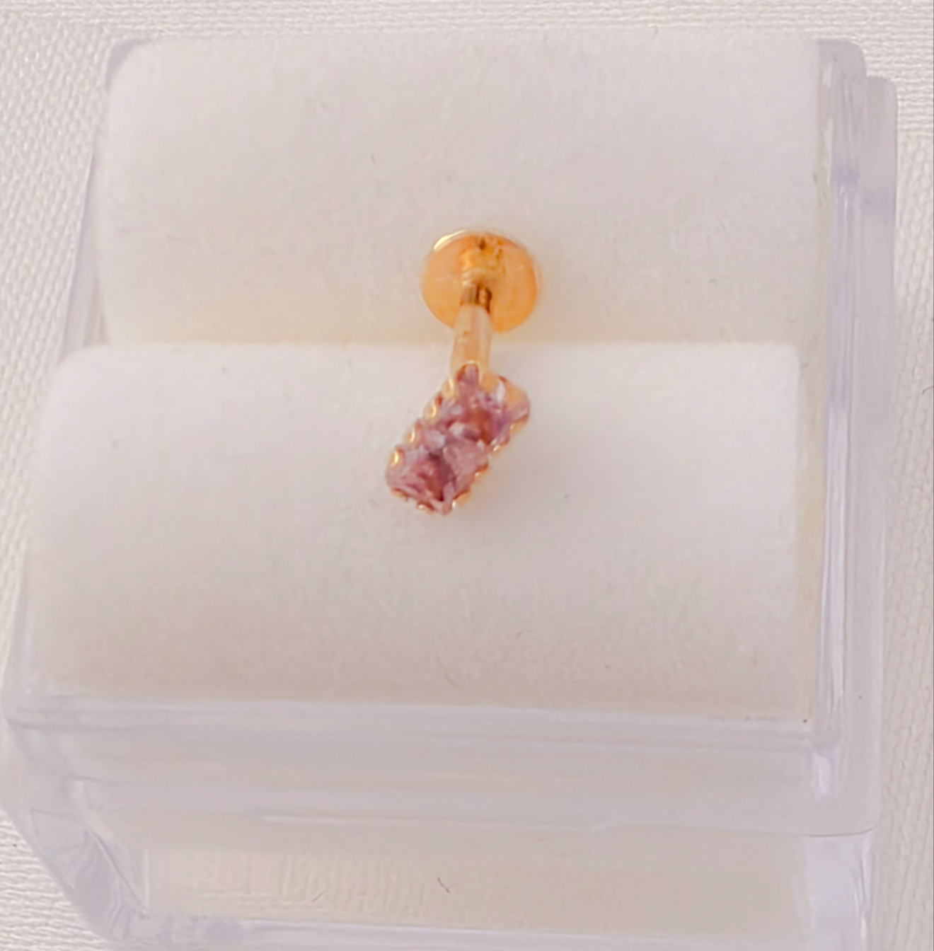Two square 2mm x 2mm C2 cartilage piercing. 14k gold