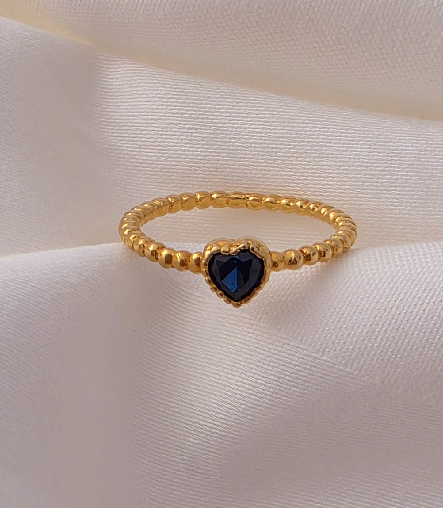 Twisted Gold Ring with Blue Stone.